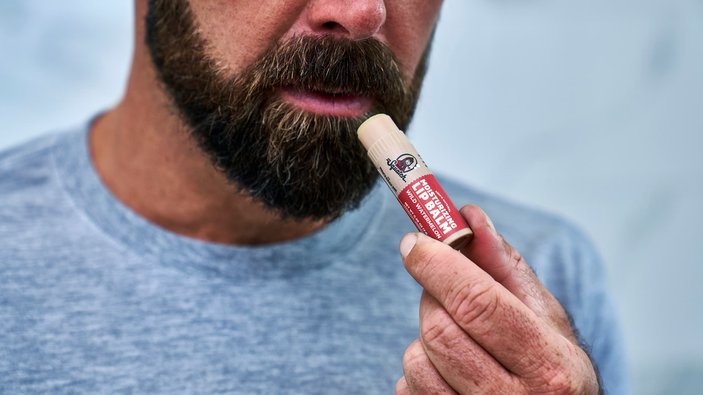Dr. Squatch Wild Watermelon Lip Balm being used